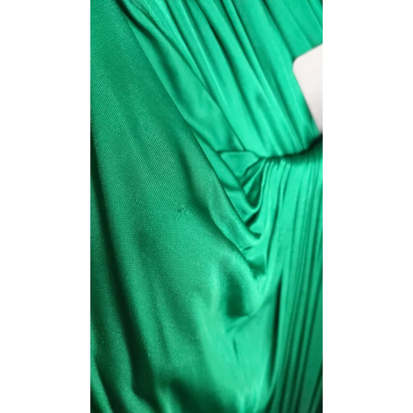 Close-up of Dolce & Gabbana Dark Green Viscose Long Sleeve Midi Dress fabric, showcasing luxurious satin texture.