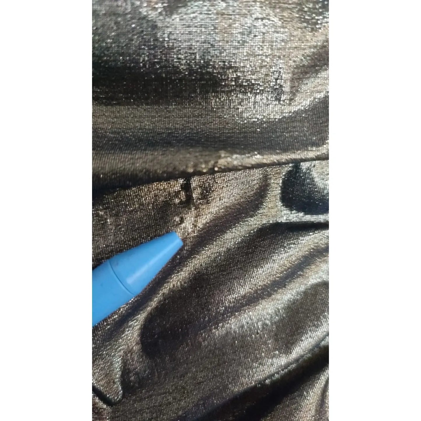 Close-up of a minor defect on Dolce & Gabbana Gold Metallic Stretch Bodycon Ruched Dress fabric with pen pointing to pull
