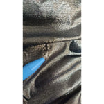Close-up of a minor defect on Dolce & Gabbana Gold Metallic Stretch Bodycon Ruched Dress fabric with pen pointing to pull