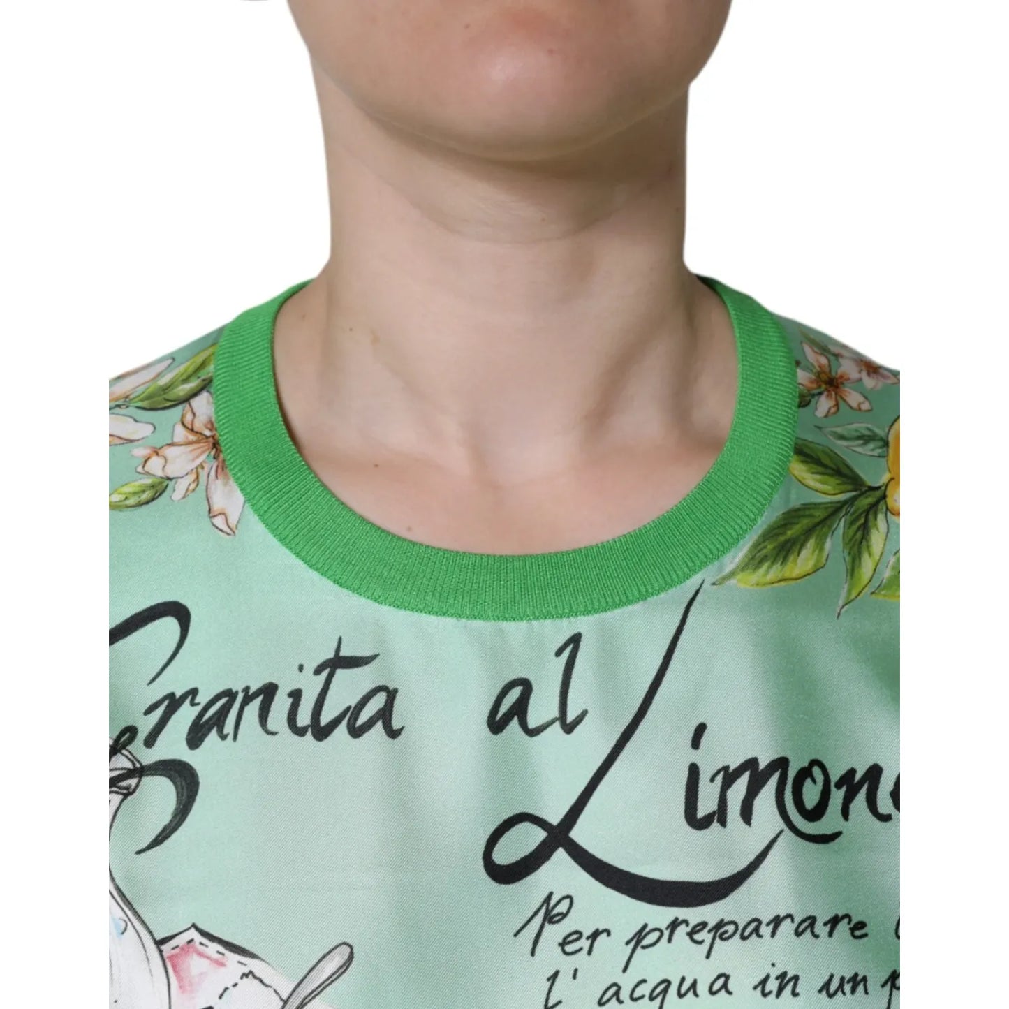 Close-up of a Dolce & Gabbana Green Lemon Print Pullover Silk Women Sweater featuring detailed text and lemon flower design.