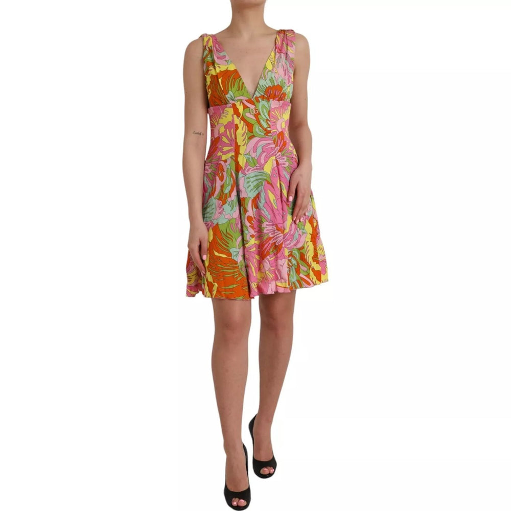 Dolce & Gabbana Multicolor Floral Silk Flared Mini Dress with bright floral pattern, model wearing high heels, featuring a V-neckline