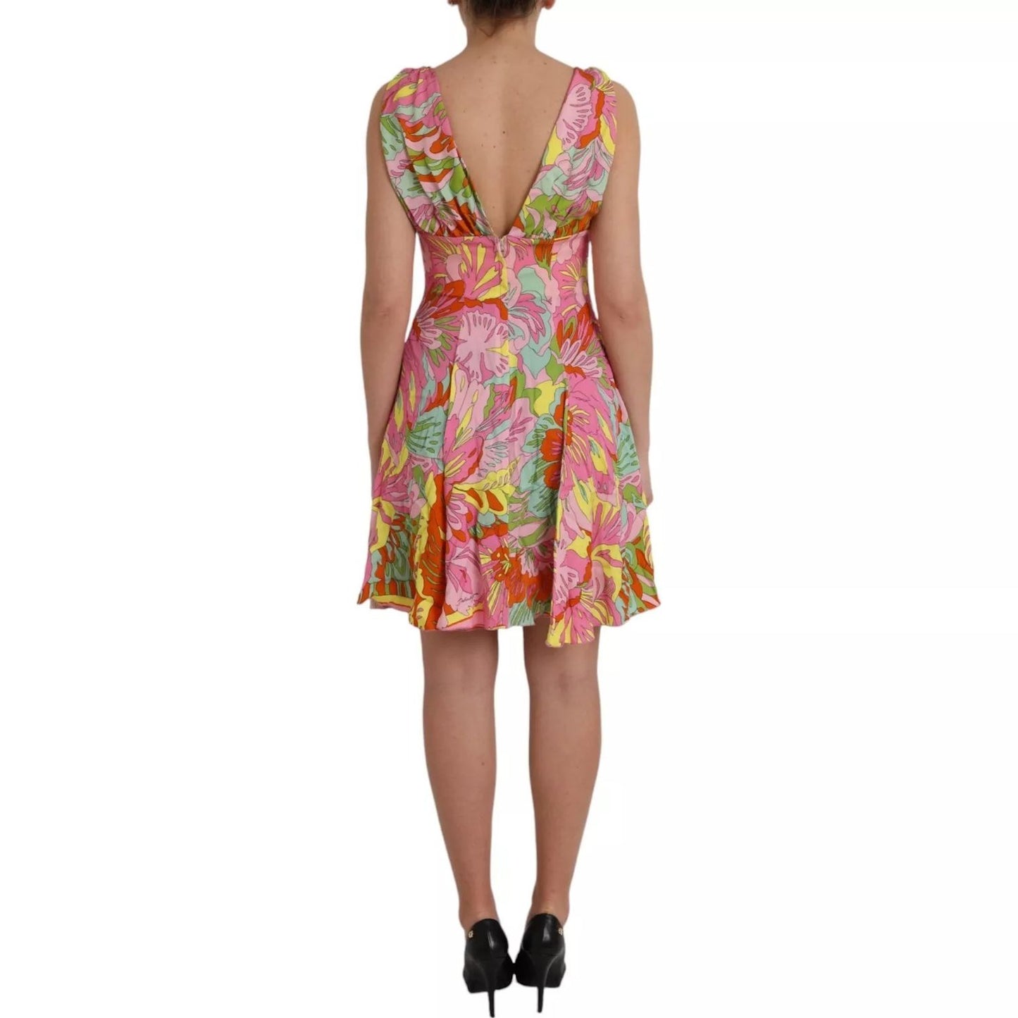 Back view of Dolce & Gabbana Multicolor Floral Silk Flared Mini Dress on model, featuring vibrant floral print and deep V-neck style.