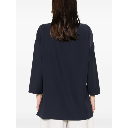 Back view of Emporio Armani cady blouse in oxford blue with drop shoulders and side slits, shown on model.