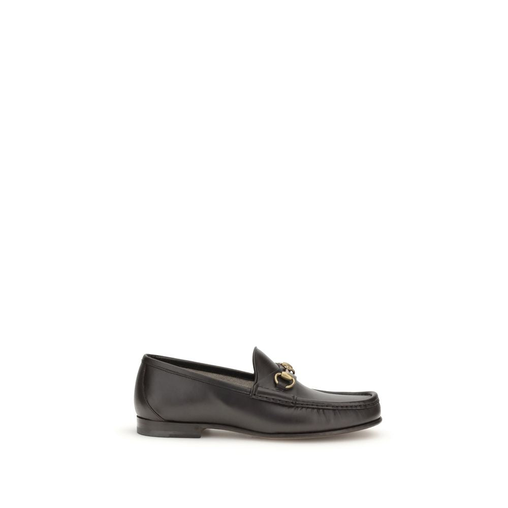Gucci Brown Calf Leather Bos Taurus Slip-On Loafers with Horsebit detail in dark brown leather, part of 1953 Collection, side view.