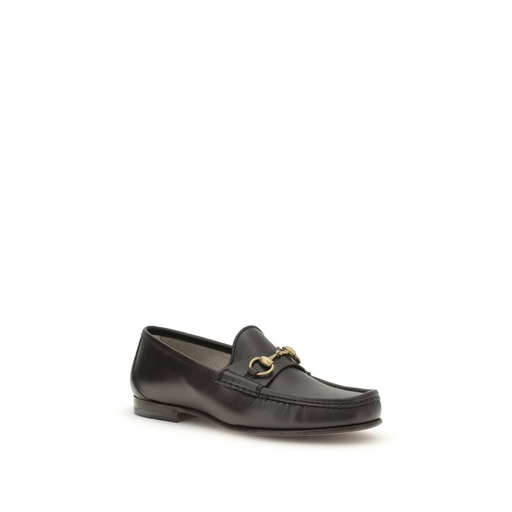 Gucci Brown Calf Leather Bos Taurus Slip-On Loafers with gold-tone Horsebit detail, classic and iconic design.