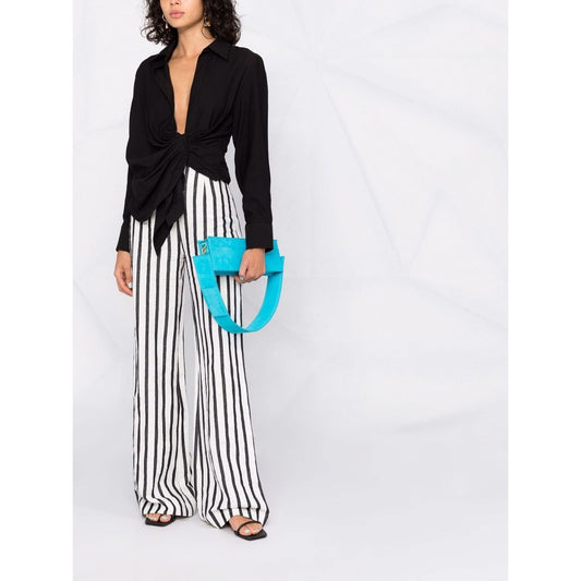Woman wearing black JACQUEMUS Shirts Black with draped and knot detailing, classic collar, long sleeves, paired with striped trousers.