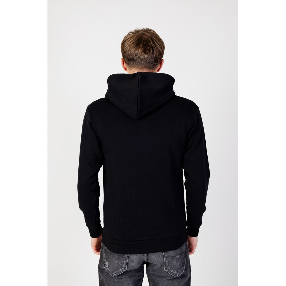 Back view of man wearing Jack Jones Black Polyester Hoodie with drawstring hood and full zip design.