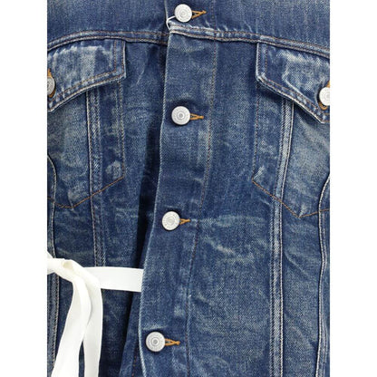Close-up of MM6 Blue Cotton Denim Jacket with front button closure and two flap patch pockets, featuring a knotted ribbon appliqué.