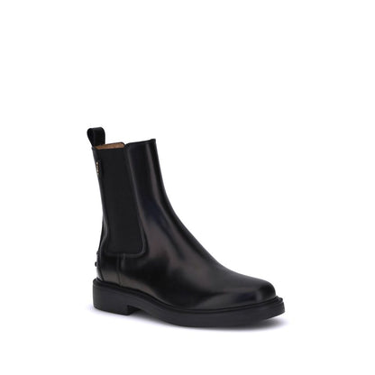 Tod's Black Calf Leather Bos Taurus Chelsea Boots with elastic inserts, rubber sole, and embossed pebbles for style and comfort.
