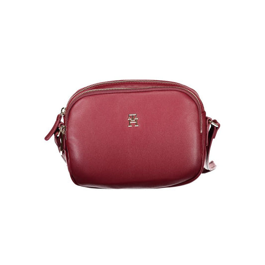 Tommy Hilfiger Red Polyester Handbag with adjustable shoulder strap, zip closure, and logo, featuring two compartments and one internal pocket.