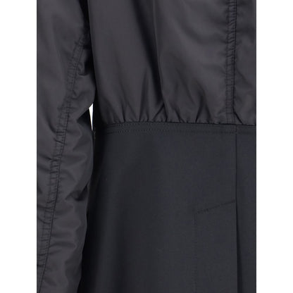 Close-up of Undercover Black Polyester Bomber with shawl lapel, zippered sleeve pocket, and ribbed cuffs, showing detailed design.