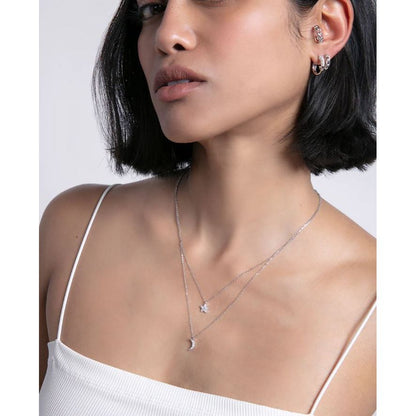 Elegant lady wearing VICEROY JEWELS Mod. 13201E000-30 earrings in silver, styled with a minimalist necklace, showcasing fashionable jewelry.