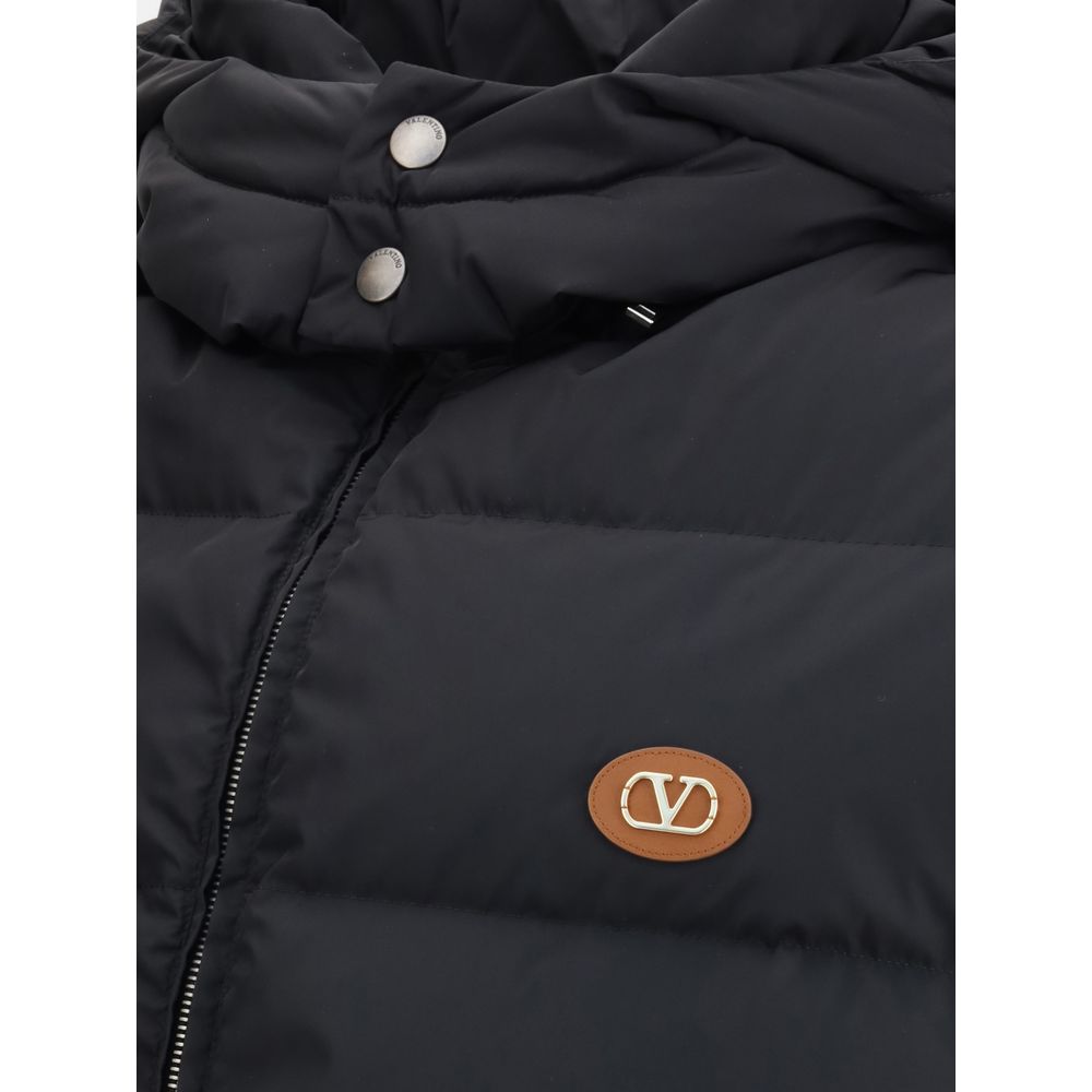 Valentino Black Goose Down Sleveless Jacket with logo patch, padded and quilted design, removable hood, and zipper closure, AW25 collection.