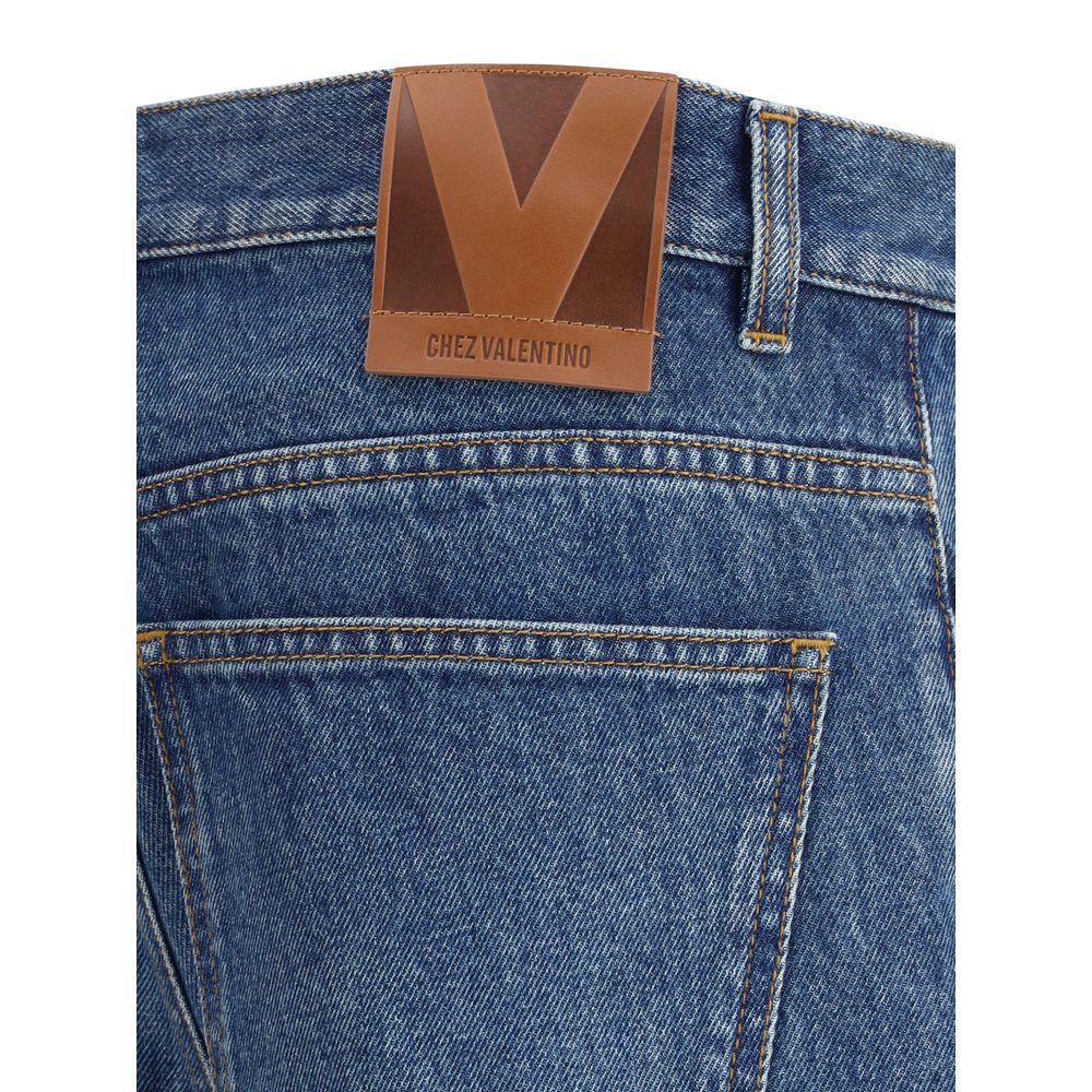 Close-up of Valentino Blue Cotton Straight-Leg Jeans with La Cour de Coeur fabric edges and logo patch on the waistband.