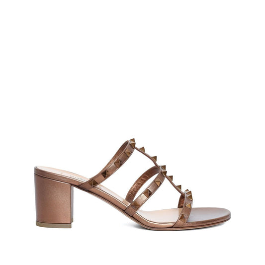 Valentino Garavani 60mm Rockstud sandals in beige leather with block heel and slip-on style. Features branded insole and iconic Rockstud detail.