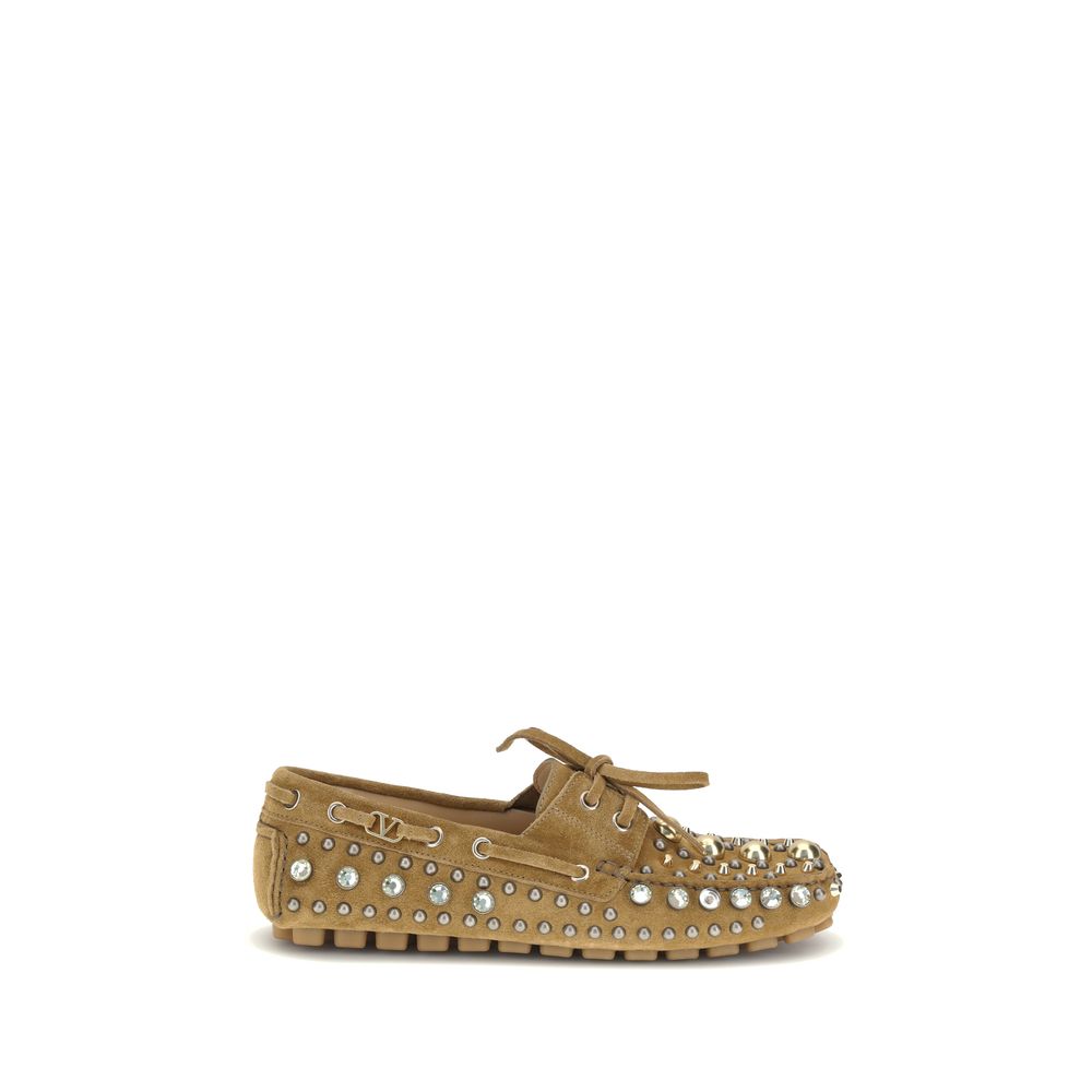 Valentino Garavani Beige Calf Leather Bos Taurus Slip-On Loafers with studs and rhinestones, showing a bold, contemporary style.