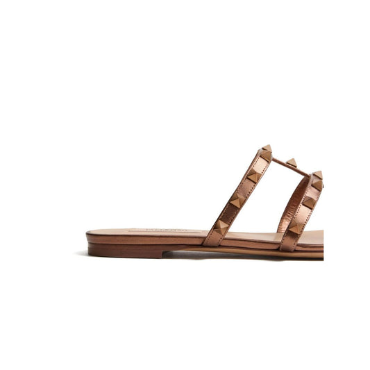 Valentino Garavani Rockstud Low Slide Sandal in Laminated Nappa Leather, brown with signature Rockstud embellishment and open toe design